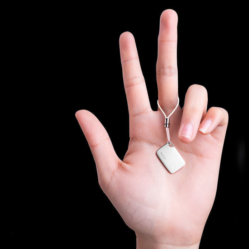 Compact Bluetooth Smart Finder Tag shown in hand demonstrating its lightweight portable size.